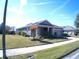 Single-story home with gray exterior, two-car garage, and landscaping at 314 Salt Marsh Ln, Groveland, FL 34736