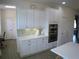 White kitchen with double ovens and ample storage at 314 Salt Marsh Ln, Groveland, FL 34736