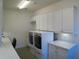 Spacious laundry room with modern washer and dryer, built in cabinets and ample counter space at 314 Salt Marsh Ln, Groveland, FL 34736