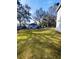 Backyard view with shed, trees, and partially visible house at 33025 Jodee Ct, Leesburg, FL 34788