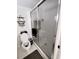 Bathroom with toilet, shower, and glass sliding door at 33025 Jodee Ct, Leesburg, FL 34788