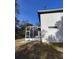 Side view of house showcasing screened porch and backyard at 33025 Jodee Ct, Leesburg, FL 34788