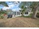 Large backyard with mature trees, outdoor seating, and room to roam at 3450 Laurel Dr, Mount Dora, FL 32757