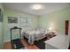 Cozy bedroom featuring wood floors, natural light and a neutral color palette at 3450 Laurel Dr, Mount Dora, FL 32757