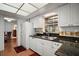 Well-lit kitchen featuring a stainless steel sink, granite countertops, and white cabinetry at 3450 Laurel Dr, Mount Dora, FL 32757