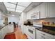 Bright kitchen showcasing white appliances, decorative tile accents, and dark granite countertops at 3450 Laurel Dr, Mount Dora, FL 32757