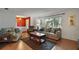 Bright living room with multiple sofas, a large window, and a dark-wood coffee table at 3450 Laurel Dr, Mount Dora, FL 32757