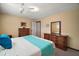 Relaxing bedroom featuring a queen bed, dark-wood furniture, and natural light at 3450 Laurel Dr, Mount Dora, FL 32757