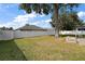 Large backyard with grassy area and fence at 36628 Grand Island Oaks Cir, Grand Island, FL 32735