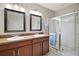 Bathroom with double vanity, large mirror, and shower at 36628 Grand Island Oaks Cir, Grand Island, FL 32735