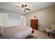 Bedroom with ceiling fan, dresser, and chair at 36628 Grand Island Oaks Cir, Grand Island, FL 32735