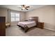 Spacious bedroom with a ceiling fan and large window at 36628 Grand Island Oaks Cir, Grand Island, FL 32735