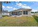 House exterior with screened patio and lawn at 36628 Grand Island Oaks Cir, Grand Island, FL 32735