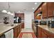 Modern kitchen featuring dark wood cabinets and tile backsplash at 36628 Grand Island Oaks Cir, Grand Island, FL 32735