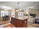 Kitchen with island, stainless steel appliances, and dark wood cabinets at 36628 Grand Island Oaks Cir, Grand Island, FL 32735