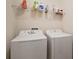 Laundry room with washer, dryer, and shelving at 36628 Grand Island Oaks Cir, Grand Island, FL 32735