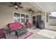 Screened patio with wicker furniture and ceiling fan at 36628 Grand Island Oaks Cir, Grand Island, FL 32735