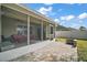 Screened patio with paver stones and seating area at 36628 Grand Island Oaks Cir, Grand Island, FL 32735