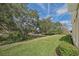 Landscaped backyard offering a tranquil view of nature at 370 Salt Marsh Ln, Groveland, FL 34736