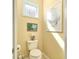 Small bathroom with toilet and window at 370 Salt Marsh Ln, Groveland, FL 34736