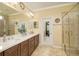 Elegant bathroom with double vanity and walk-in shower at 370 Salt Marsh Ln, Groveland, FL 34736