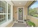 Welcoming entryway with a screened porch and lush plants at 370 Salt Marsh Ln, Groveland, FL 34736