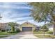 Charming house with a gray garage door and neatly landscaped yard at 370 Salt Marsh Ln, Groveland, FL 34736