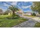 Single-Gathering home with a palm tree and a paver driveway at 370 Salt Marsh Ln, Groveland, FL 34736