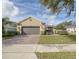 Inviting curb appeal with a paver driveway and lush landscaping at 370 Salt Marsh Ln, Groveland, FL 34736