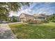 Single-story house with a well-maintained lawn and driveway at 370 Salt Marsh Ln, Groveland, FL 34736