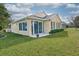 Back exterior view of the house with sliding doors leading to a patio at 370 Salt Marsh Ln, Groveland, FL 34736