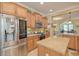 Spacious kitchen featuring stainless steel appliances and light wood cabinets at 370 Salt Marsh Ln, Groveland, FL 34736