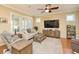 Spacious living room with a large TV and comfortable seating at 370 Salt Marsh Ln, Groveland, FL 34736