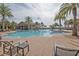 Resort-style pool with lounge chairs and palm trees at 370 Salt Marsh Ln, Groveland, FL 34736