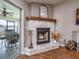 Whitewashed brick fireplace with wood mantel and glass doors at 37146 Calhoun Rd, Eustis, FL 32736