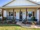 Charming front porch with wooden posts and rocking chairs at 37146 Calhoun Rd, Eustis, FL 32736