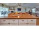 Large kitchen island with wood countertop and white cabinetry at 37146 Calhoun Rd, Eustis, FL 32736