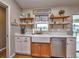 Charming kitchen with a farmhouse sink, white cabinets, and open shelving at 37146 Calhoun Rd, Eustis, FL 32736