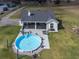 Round above-ground pool with surrounding patio and backyard at 37146 Calhoun Rd, Eustis, FL 32736