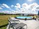 Relaxing above-ground pool with lounge chairs and patio seating at 37146 Calhoun Rd, Eustis, FL 32736