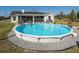 Inviting above-ground pool with ample surrounding patio space at 37146 Calhoun Rd, Eustis, FL 32736