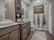 Elegant bathroom with double vanity and modern fixtures at 3735 Conservation Trl, The Villages, FL 32163