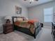 Spacious bedroom with a queen-sized bed and neutral color palette at 3735 Conservation Trl, The Villages, FL 32163