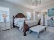 Luxurious main bedroom with a king bed and ensuite bathroom at 3735 Conservation Trl, The Villages, FL 32163