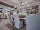 Farmhouse-style dining room with chandelier and wooden table at 3735 Conservation Trl, The Villages, FL 32163