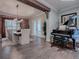 Grand dining room featuring a brick wall and grand piano at 3735 Conservation Trl, The Villages, FL 32163