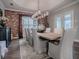 Rustic dining room with brick accent wall and wooden table at 3735 Conservation Trl, The Villages, FL 32163