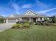 One-story home with gray siding, landscaping, and a two-car garage at 3735 Conservation Trl, The Villages, FL 32163