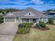 One-story house with two-car garage and landscaped yard at 3735 Conservation Trl, The Villages, FL 32163