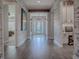 Bright hallway with wood-look floors and barn-wood walls at 3735 Conservation Trl, The Villages, FL 32163